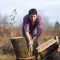 Lumberjack chopping wood for winter, Young man chopping woods with an axe
