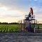 A female engineer at work on an European oil well during dusk ti