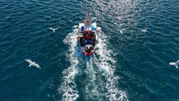 Aerial drone photo of traditional wooden fishing boat cruising i