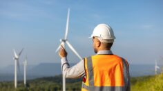 Engineer India man working with tablet at windmill farm Generati