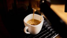 Detail of a professional coffe maker dripping coffe into an empty cup in a cafeteria