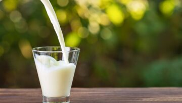 milk from jug pouring into glass
