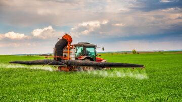 Farmer spraying wheat crops