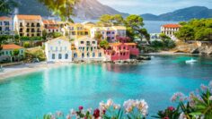 Turquoise colored bay in Mediterranean sea with beautiful colorful houses in Assos village in Kefalonia, Greece