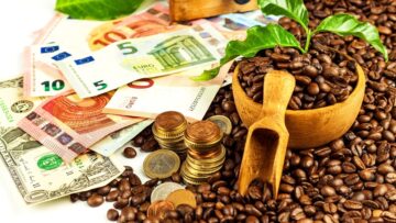 Coffee beans and money. Fair Trade. Sale of coffee. Commodity trade. Fresh coffee beans.