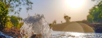Irrigation water flow from pipe to canal for agriculture fields , slow motion water flash