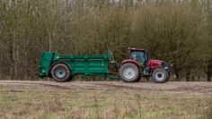 Case Puma 340 red tractor towing a Samson Flex-16 green muck spreader