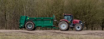 Case Puma 340 red tractor towing a Samson Flex-16 green muck spreader